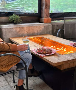 The Shed Eatery, sitting by fire with pizza and wine
