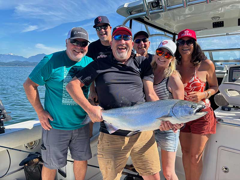 First Fish Charters group smiling holding fish